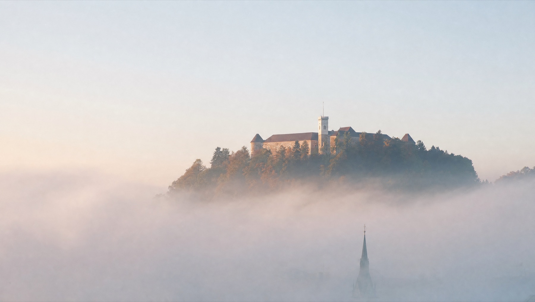 Ljubljana castle above morning fog